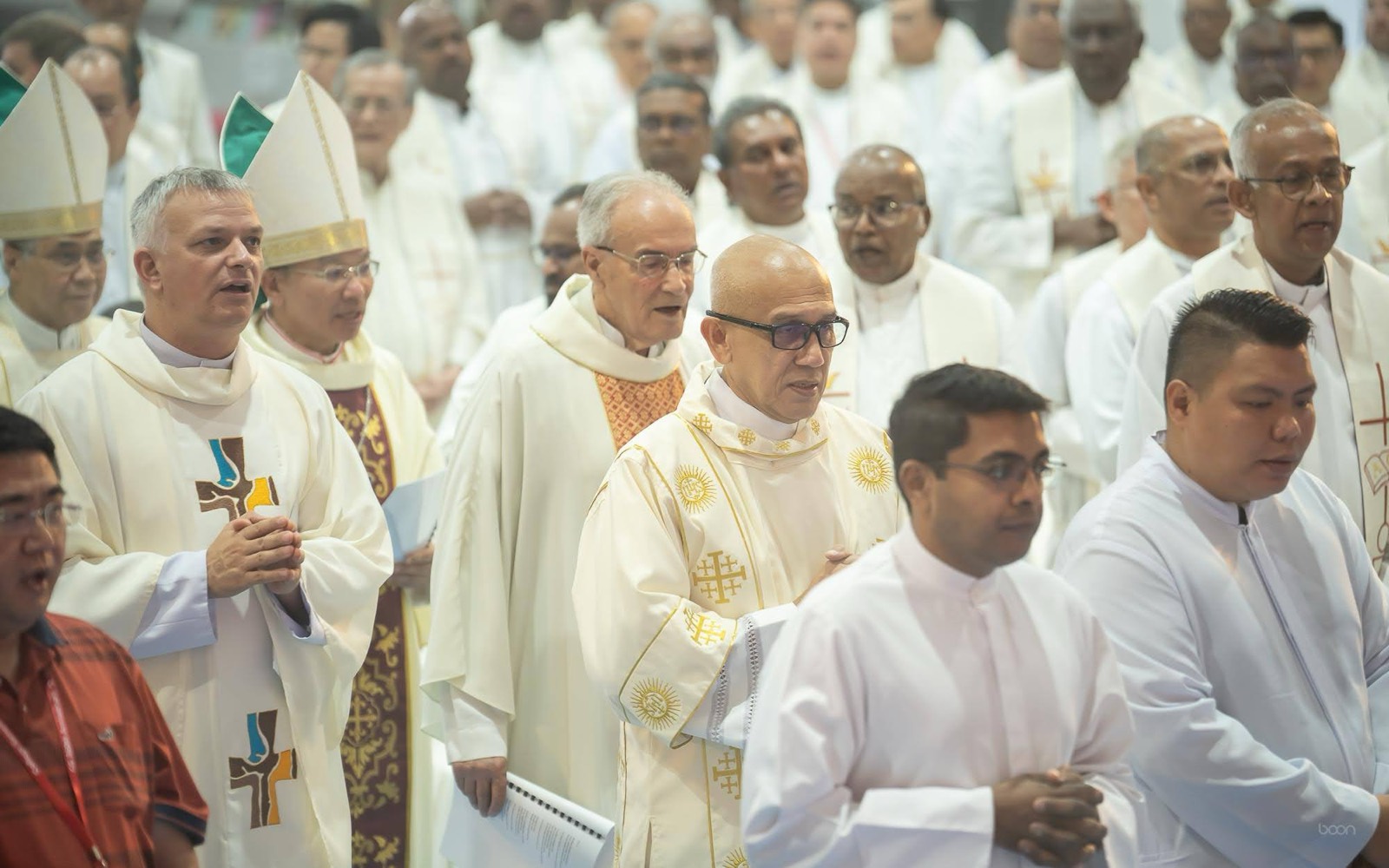 Clergy processing through the hall for the anniversary Mass