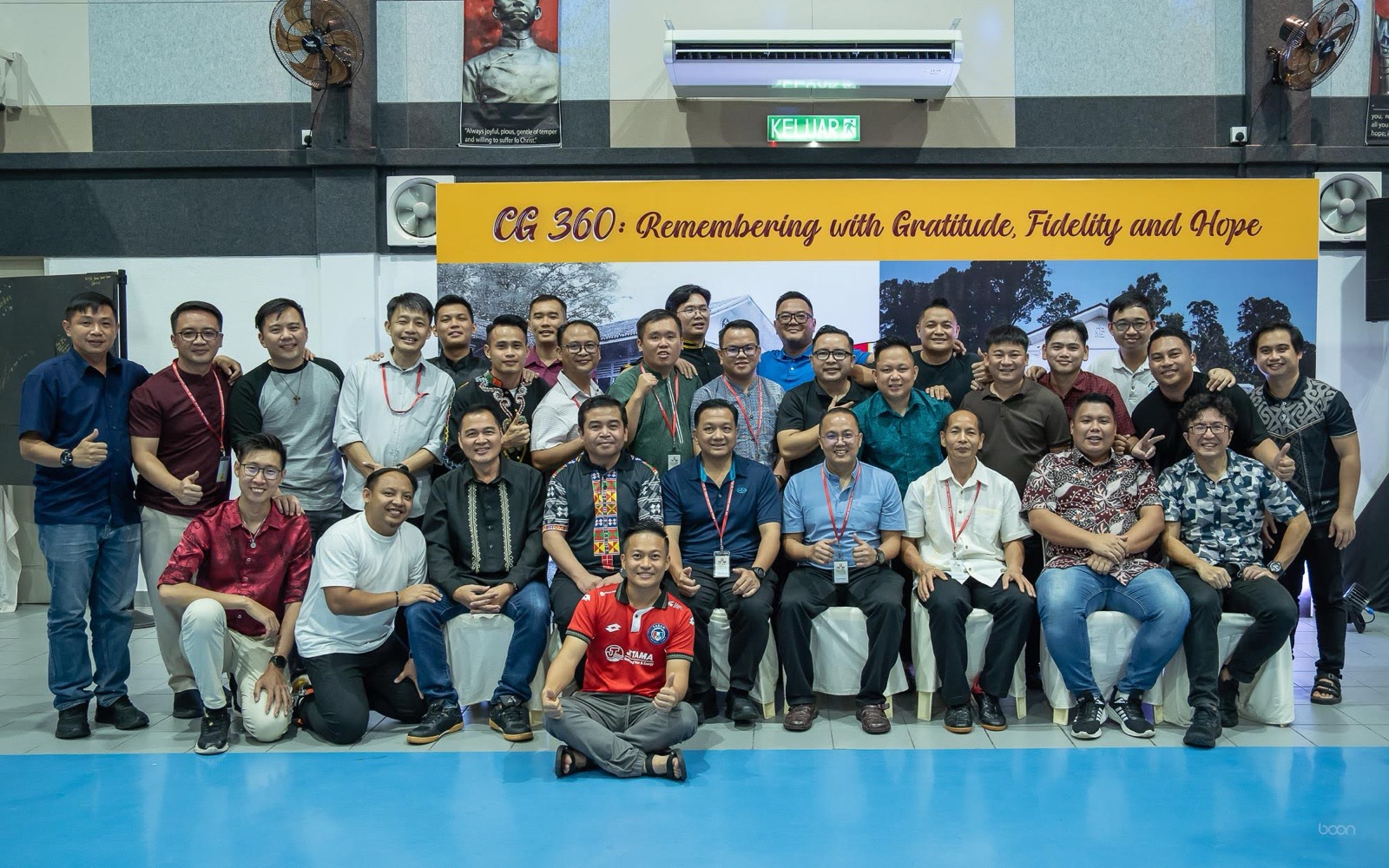 A group of alumni before the CG 360 backdrop