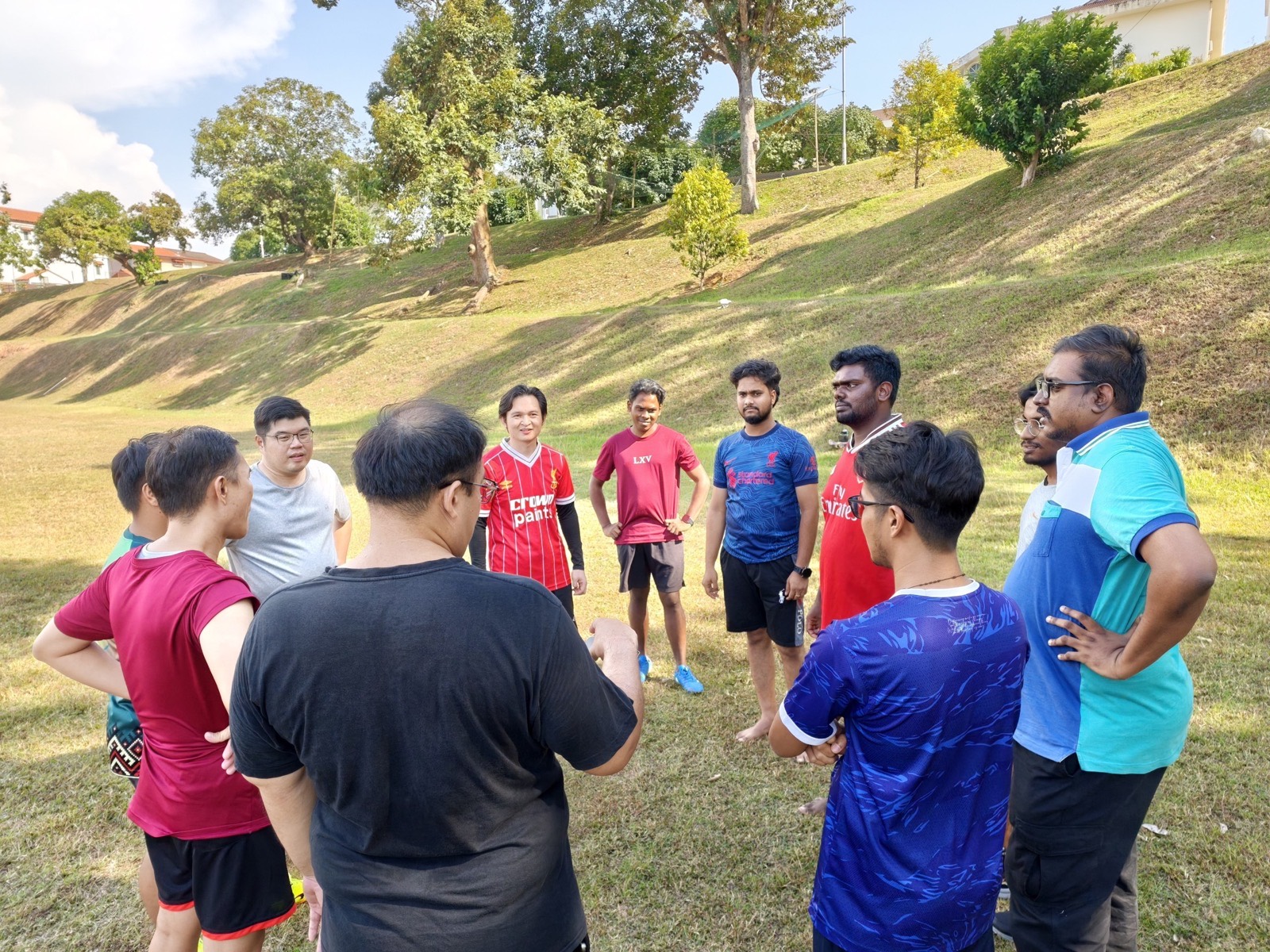 Players gathered on the hill at the edge of the grounds