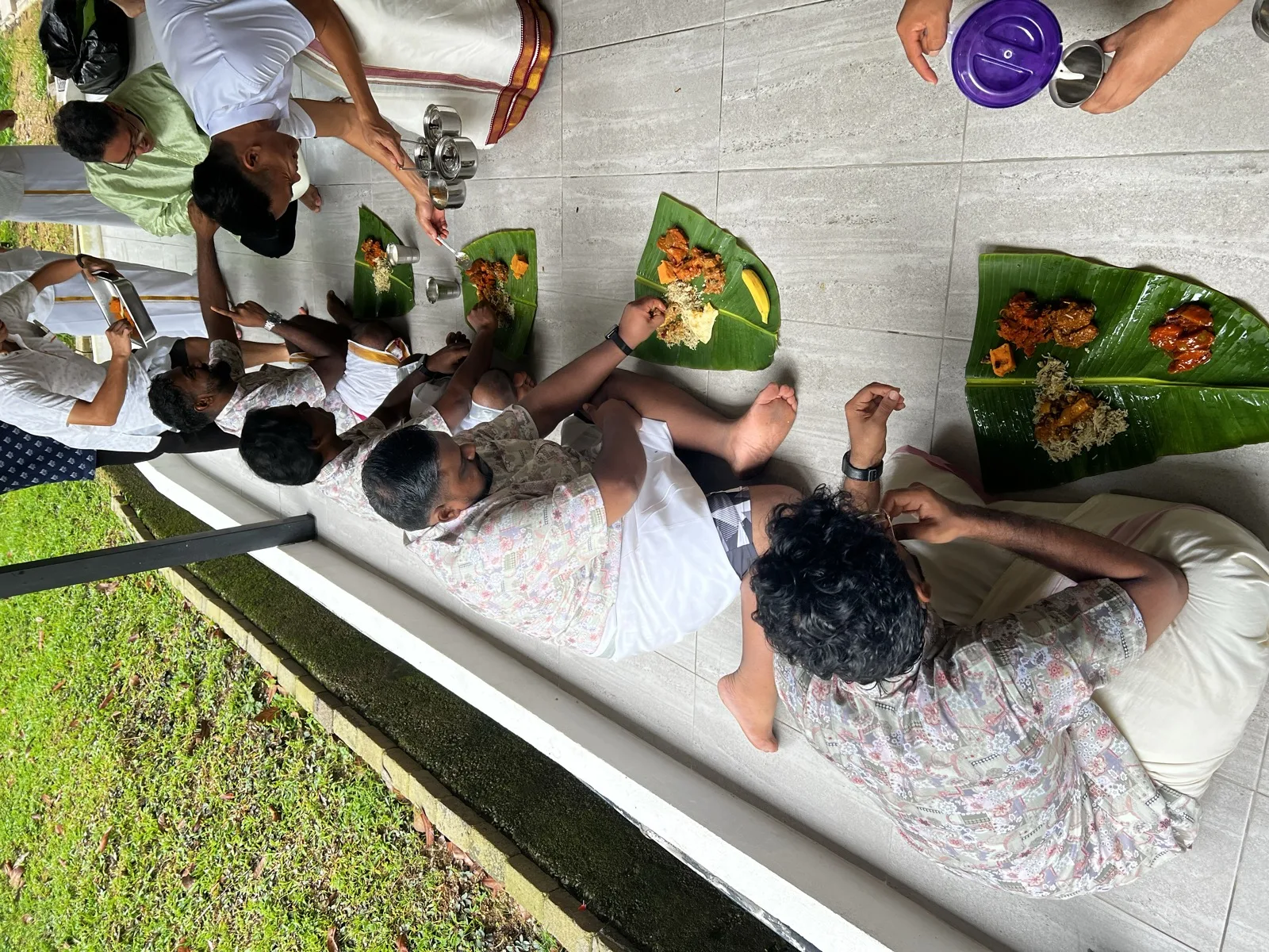 A community meal served on banana leaves outdoors