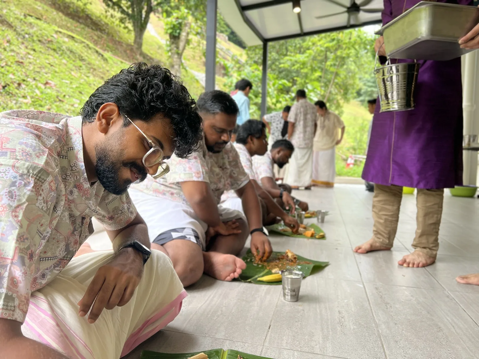 Seminarians and guests sharing a meal on banana leaves