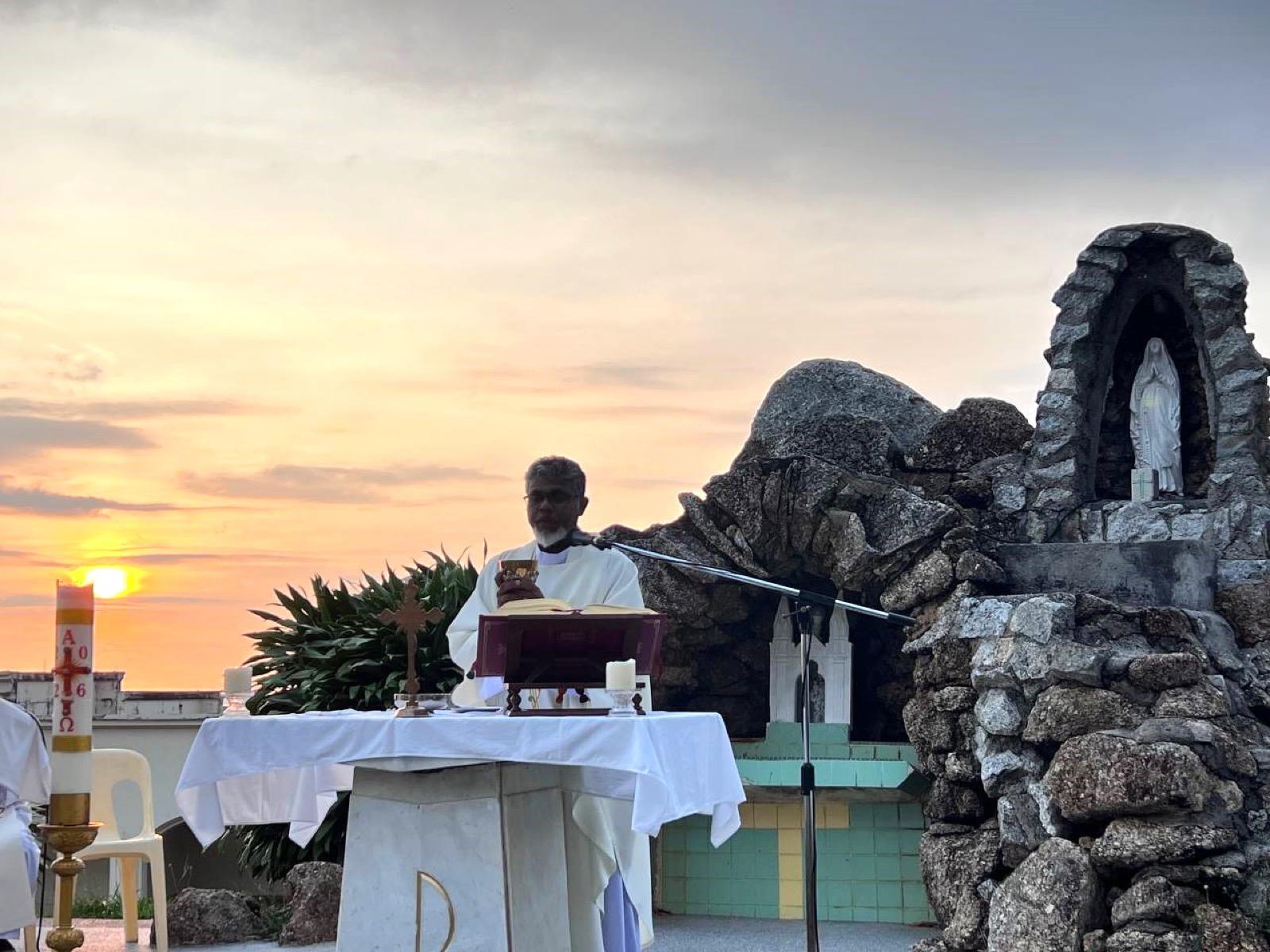 Evening prayer at the outdoor grotto as the sun sets